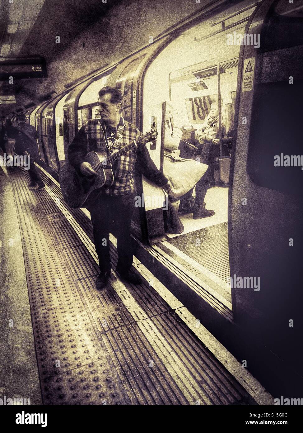 Busker on the Underground - Smartphone Captured Stock Image