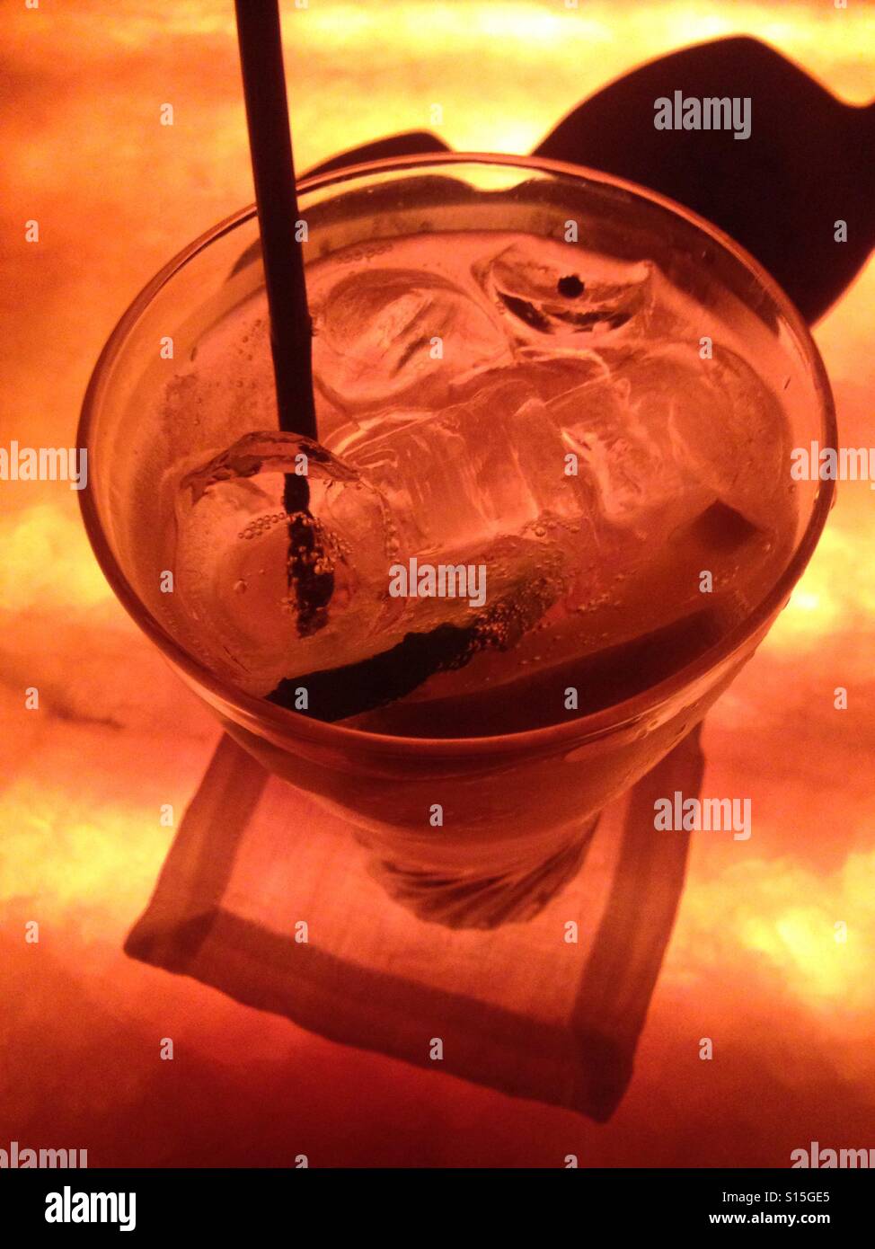 Cucumber gin tonic backlit with warm amber glow Stock Photo Alamy