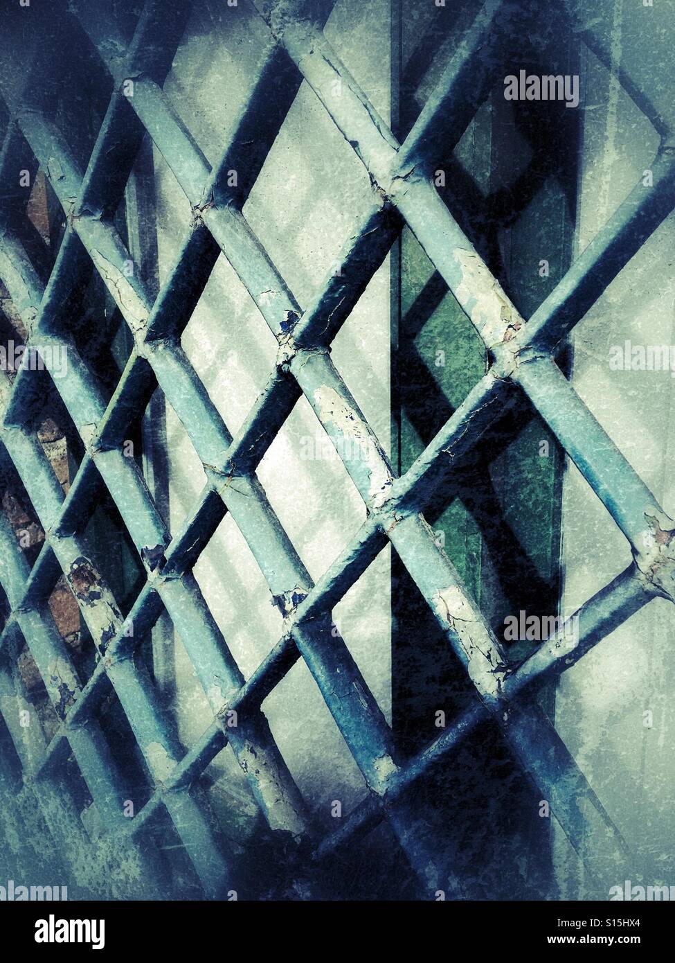 Painted metal grille covering a window - Smartphone Captured Stock Image