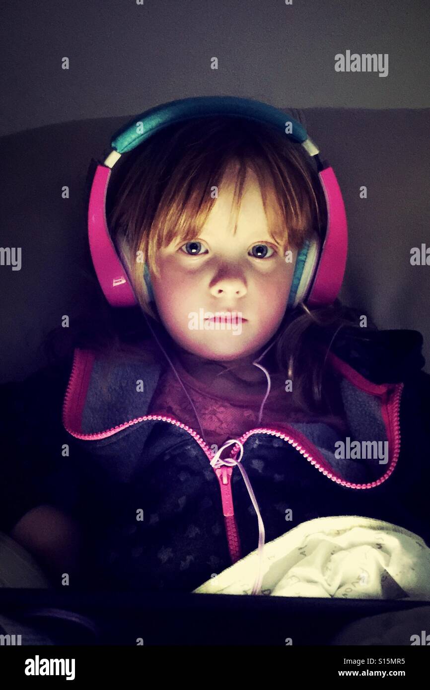 Young girl wearing headphones looking ahead Stock Photo