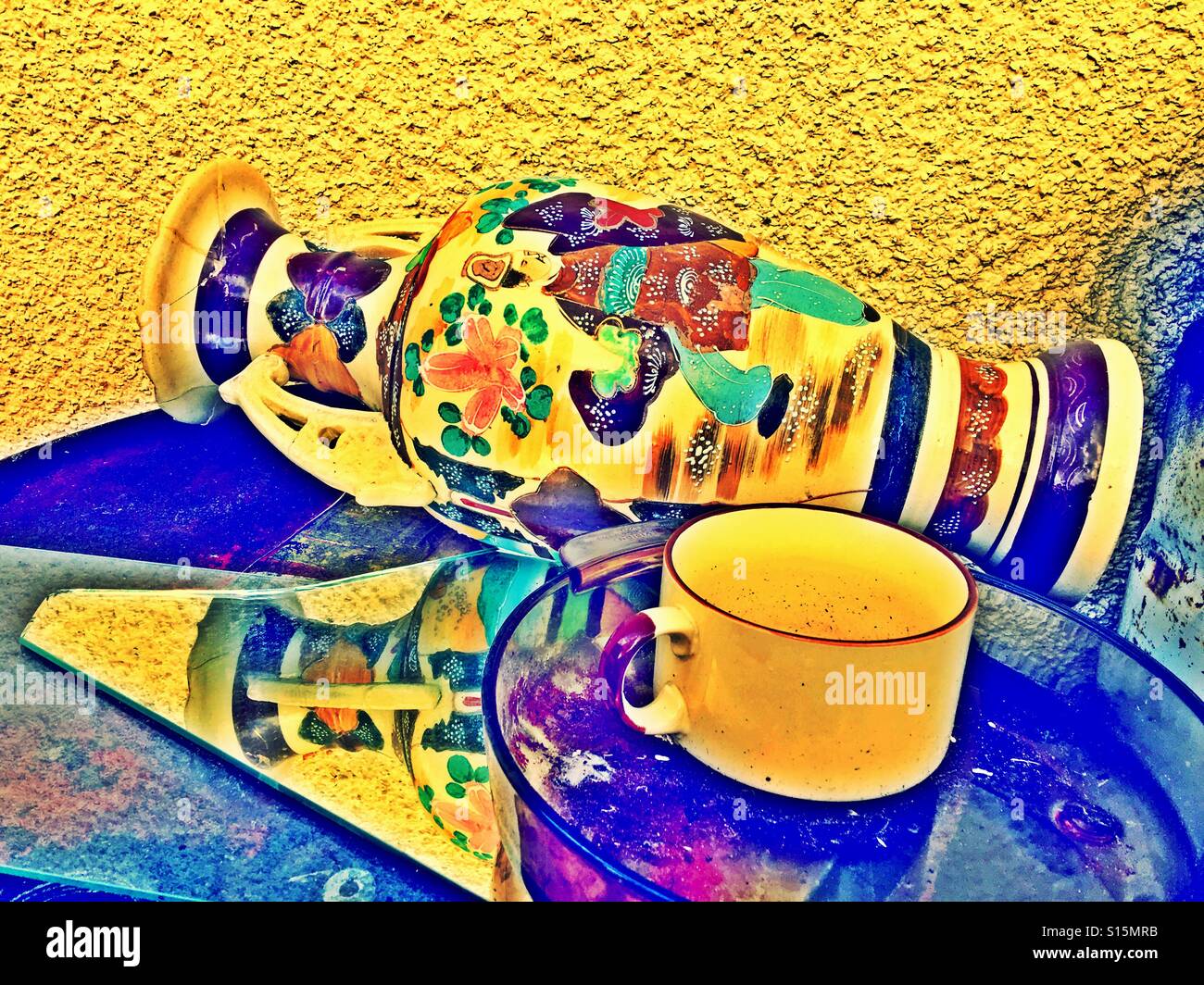 Discarded vase, cup, plate and broken mirror on a table outdoors. - Smartphone Captured Stock Image