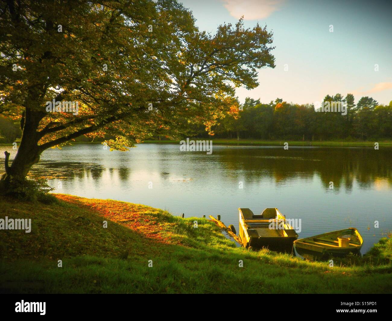 Two fishing boats tied up at the ide of a fishing loch, Ayrshire, Scotland, UK - Smartphone Captured Stock Image