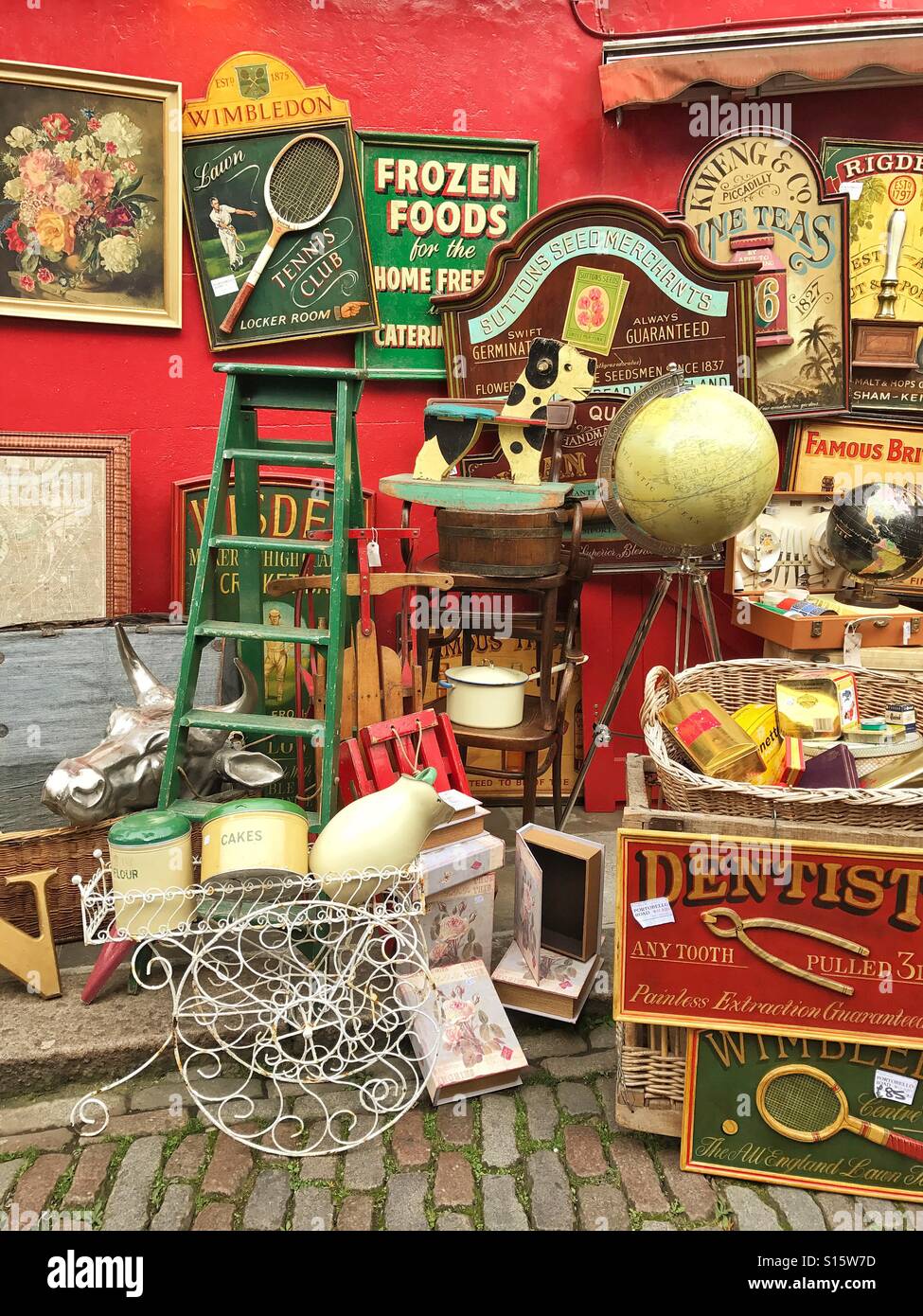 Antiques and bric-a-brac on display outside shop in Portobello Road Market, Notting Hill, London - Smartphone Captured Stock Image