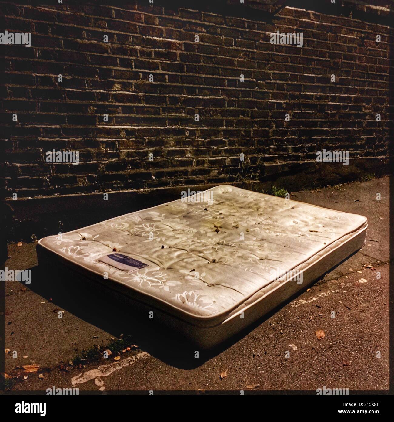 Mattress dumped in street Stock Photo Alamy