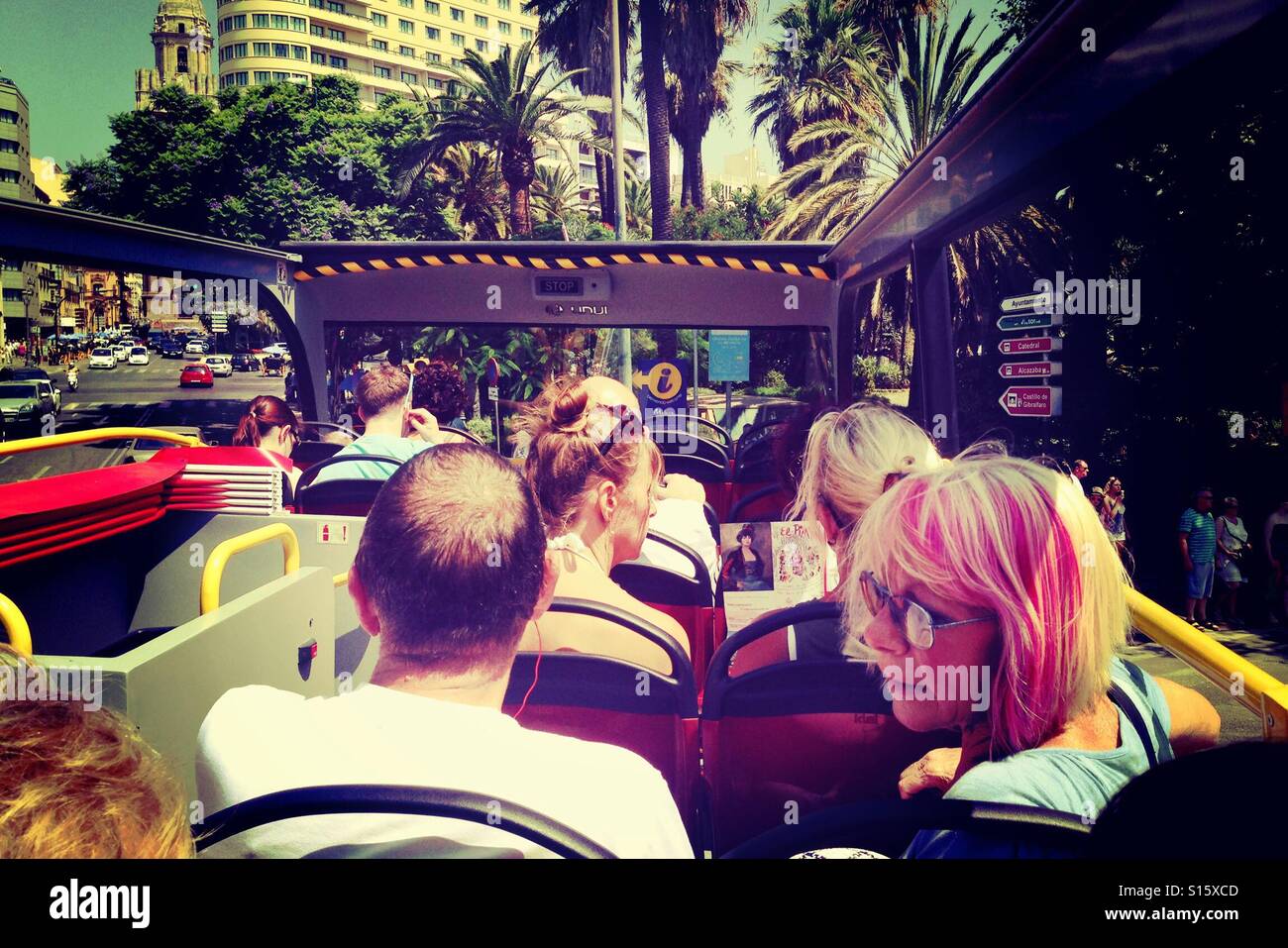 Tourists on an open top tour bus in Malaga Spain - Smartphone Captured Stock Image