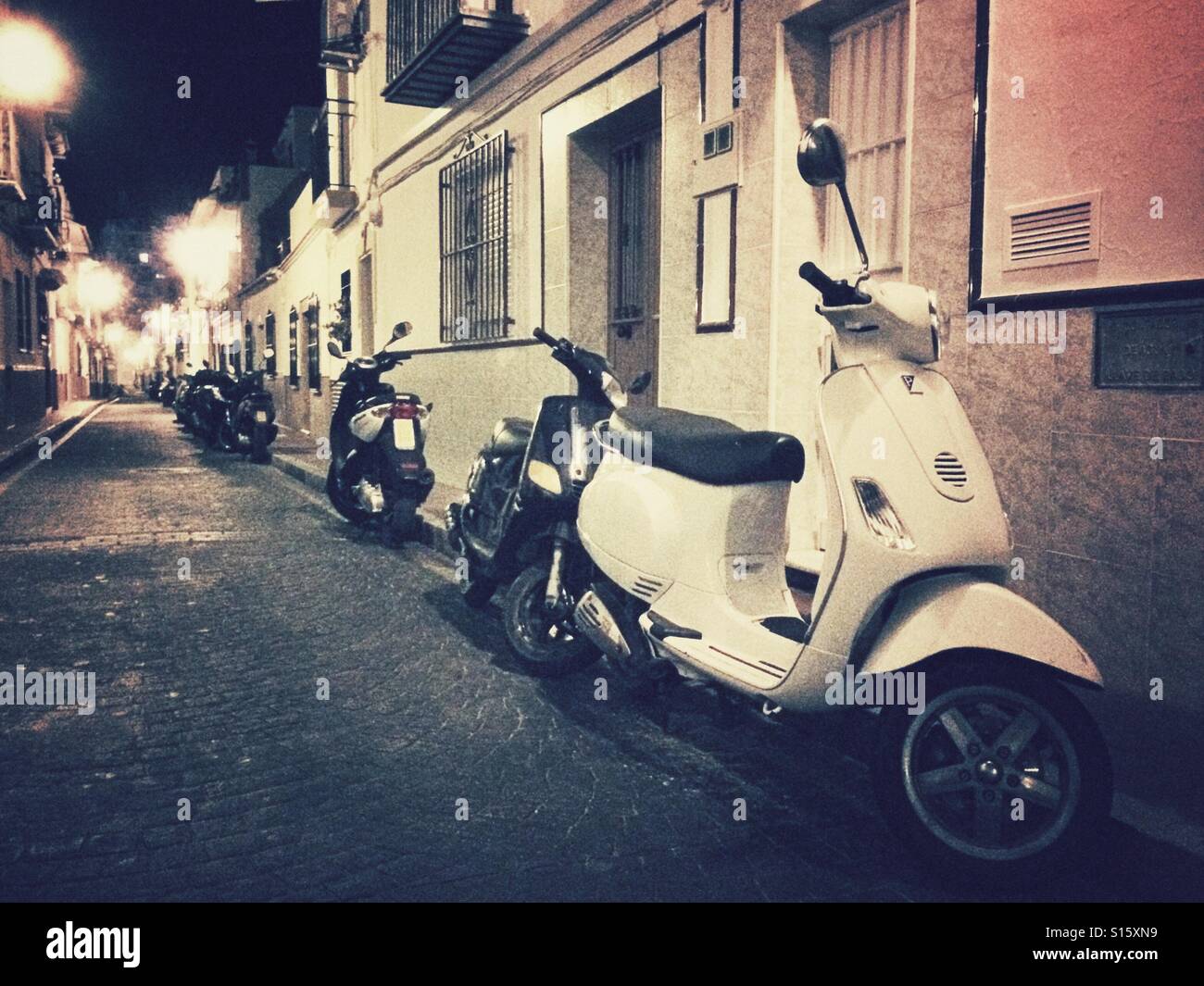 Scooters parked in old Spanish street Stock Photo - Alamy