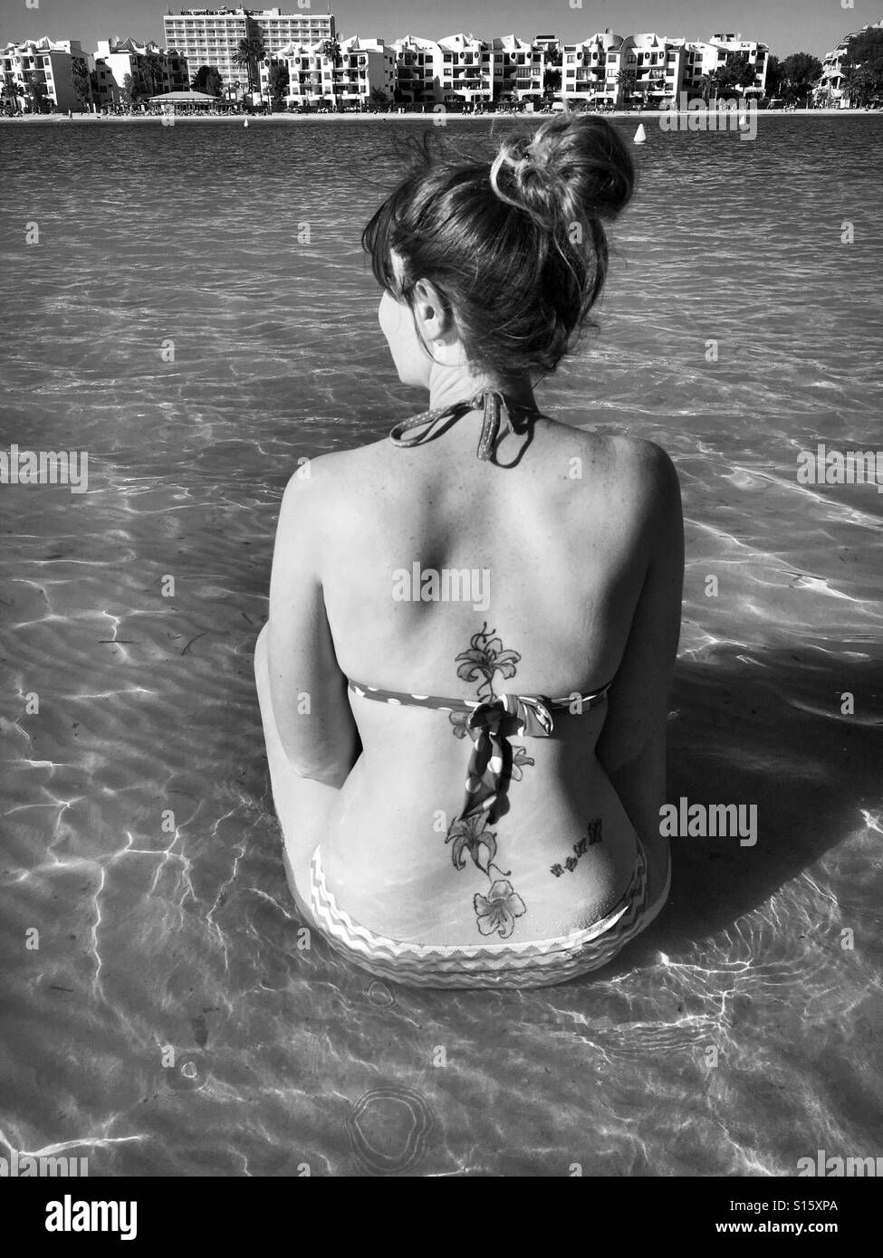 Young woman in bikini sat in the Mediterranean Sea Mallorca Stock Photo