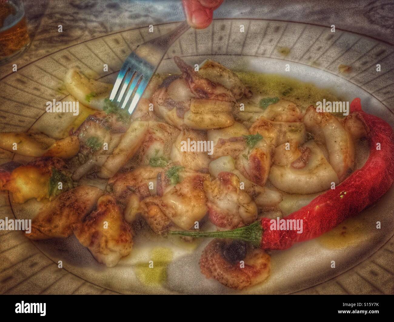 Enjoying a plate of sepia in a Spanish tapas bar - Smartphone Captured Stock Image