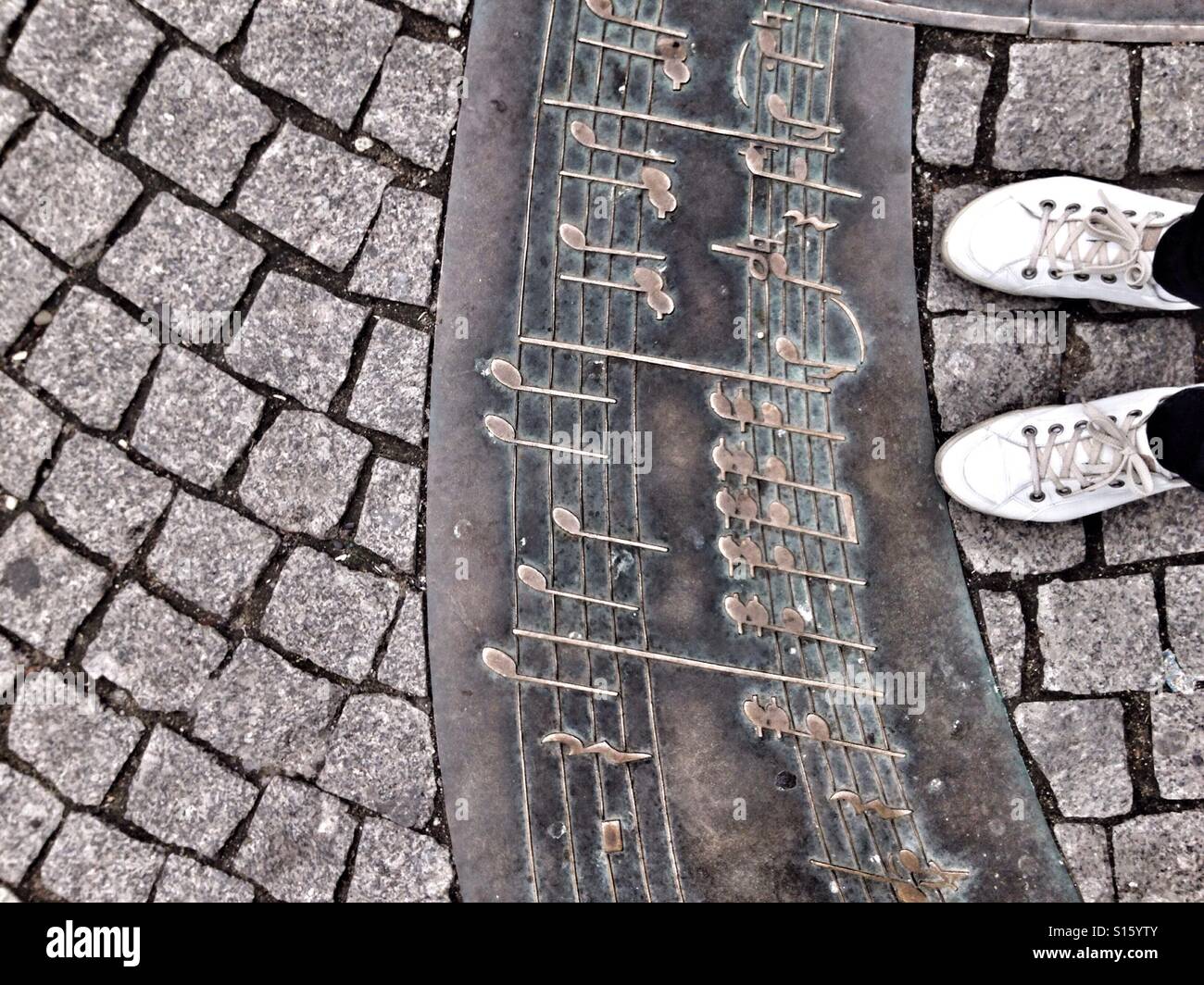 Standing at street plaque with notes - Smartphone Captured Stock Image