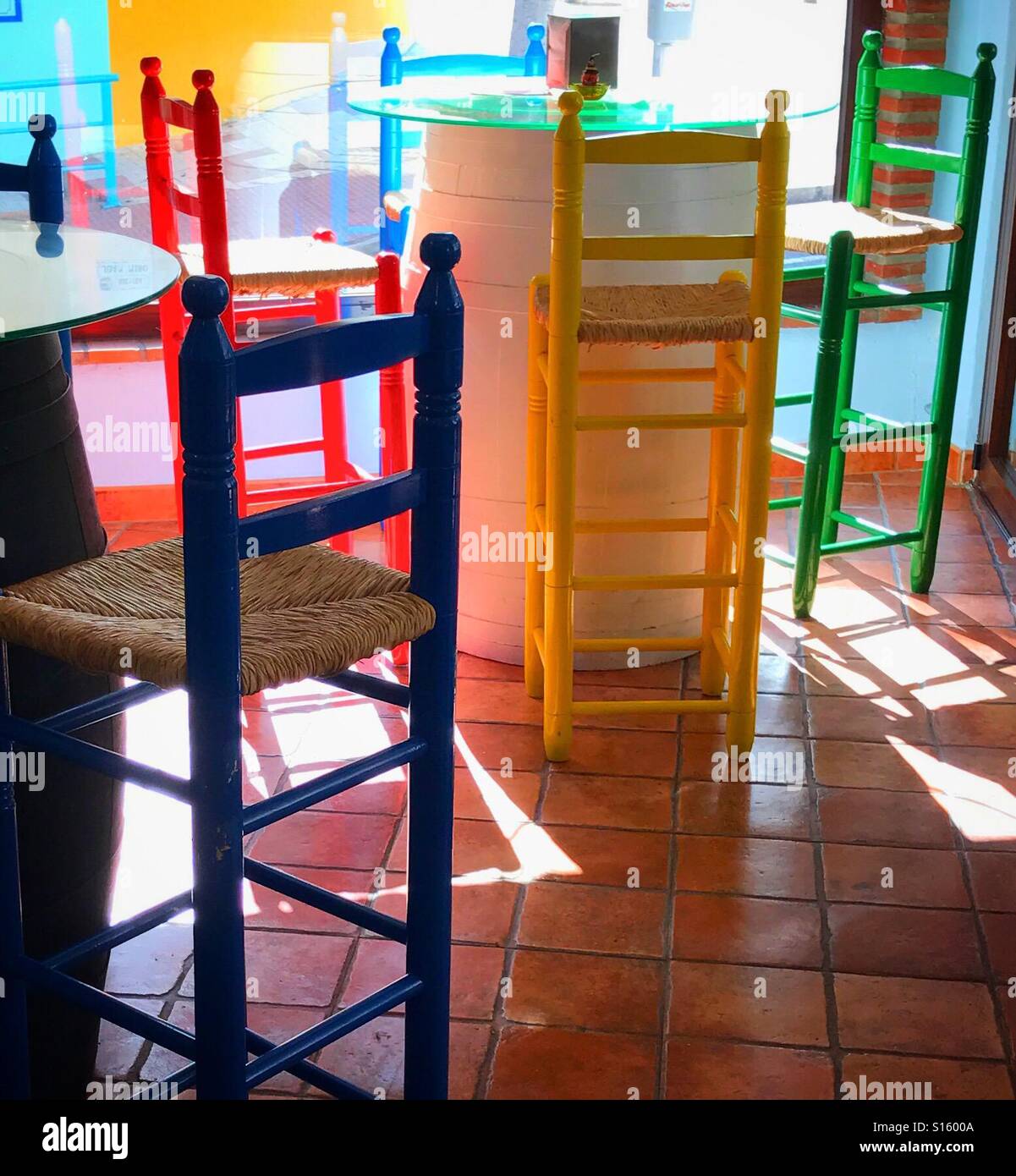Brightly coloured tables and chairs of a tapas bar and restaurant in Torremolinos, Spain - Smartphone Captured Stock Image