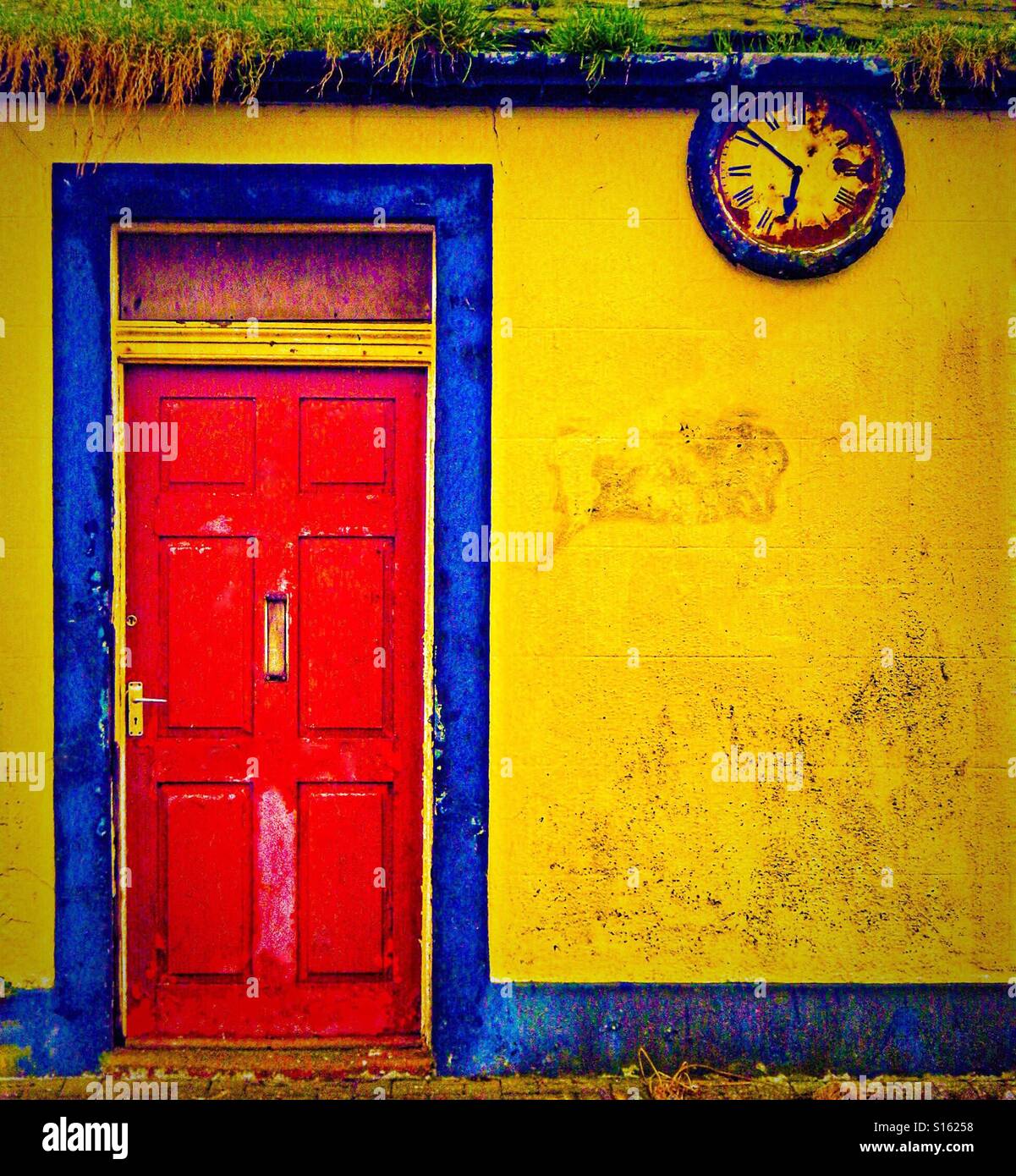 Red door and yellow wall, Irvine, Scotland, UK - Smartphone Captured Stock Image