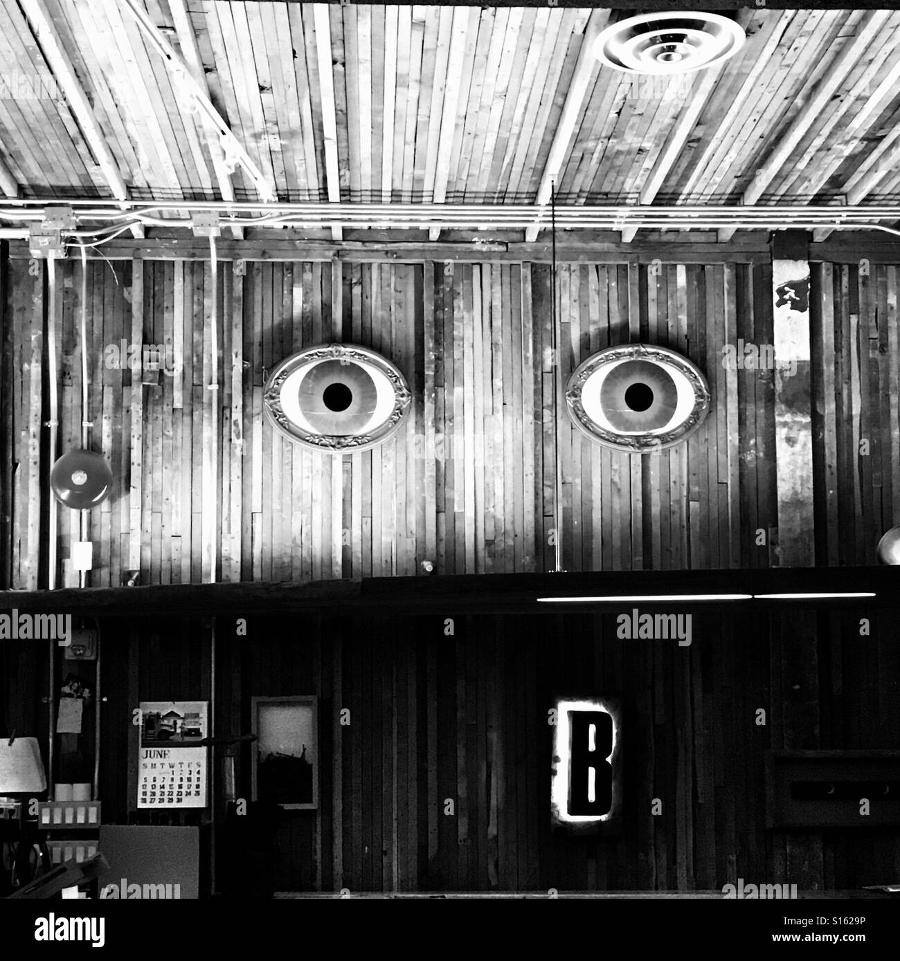 Eyes on wall of bar Stock Photo