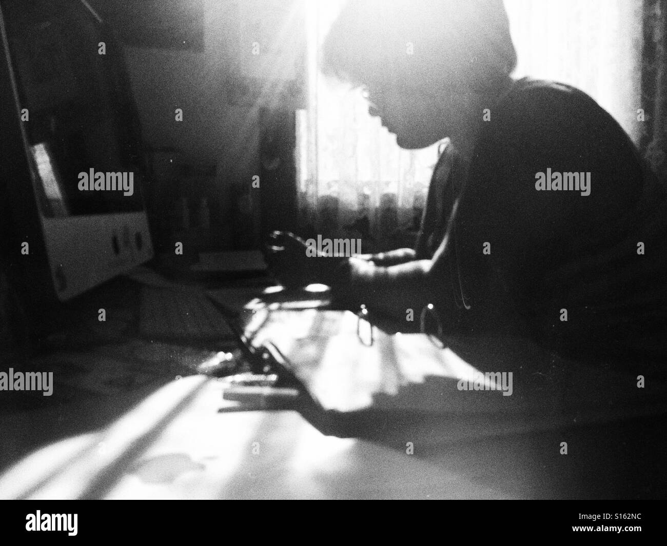 Teenager studying for exams, on a sunny day. - Smartphone Captured Stock Image