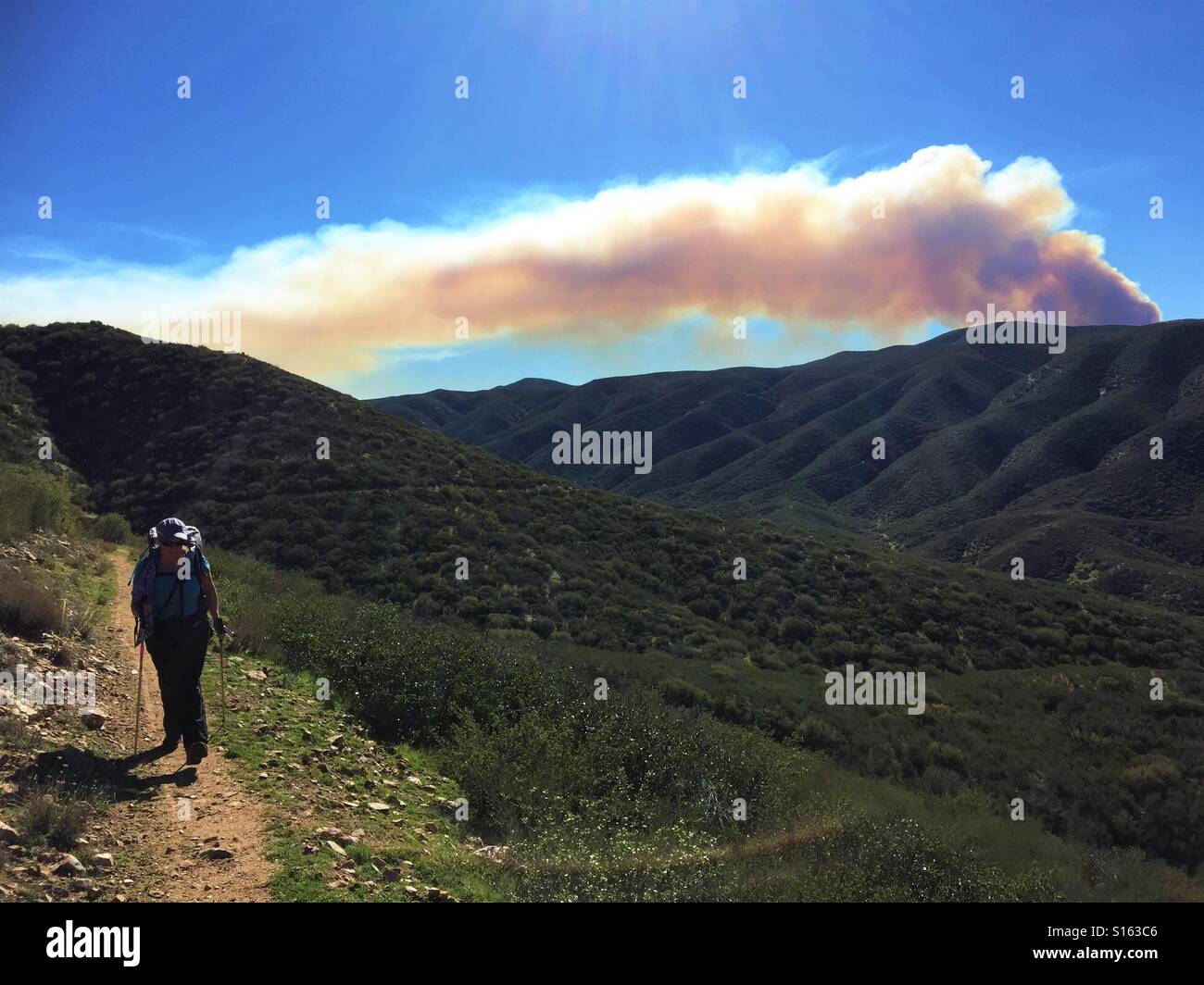 Hiking away from the fire Stock Photo