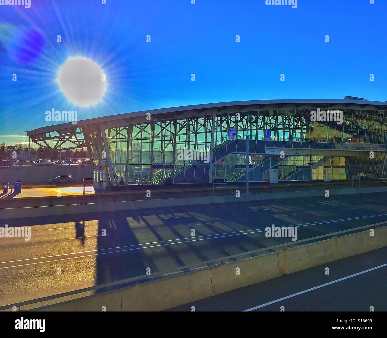 Light rail transit station, bright sun and shadows across Crowchild Trail, Calgary, Alberta, Canada - Smartphone Captured Stock Image