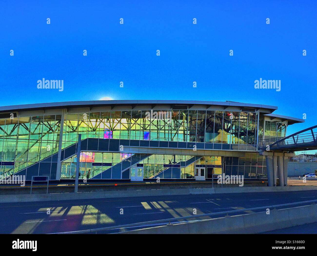 Light rail transit station, bright sun and shadows across Crowchild Trail, Calgary, Alberta, Canada - Smartphone Captured Stock Image