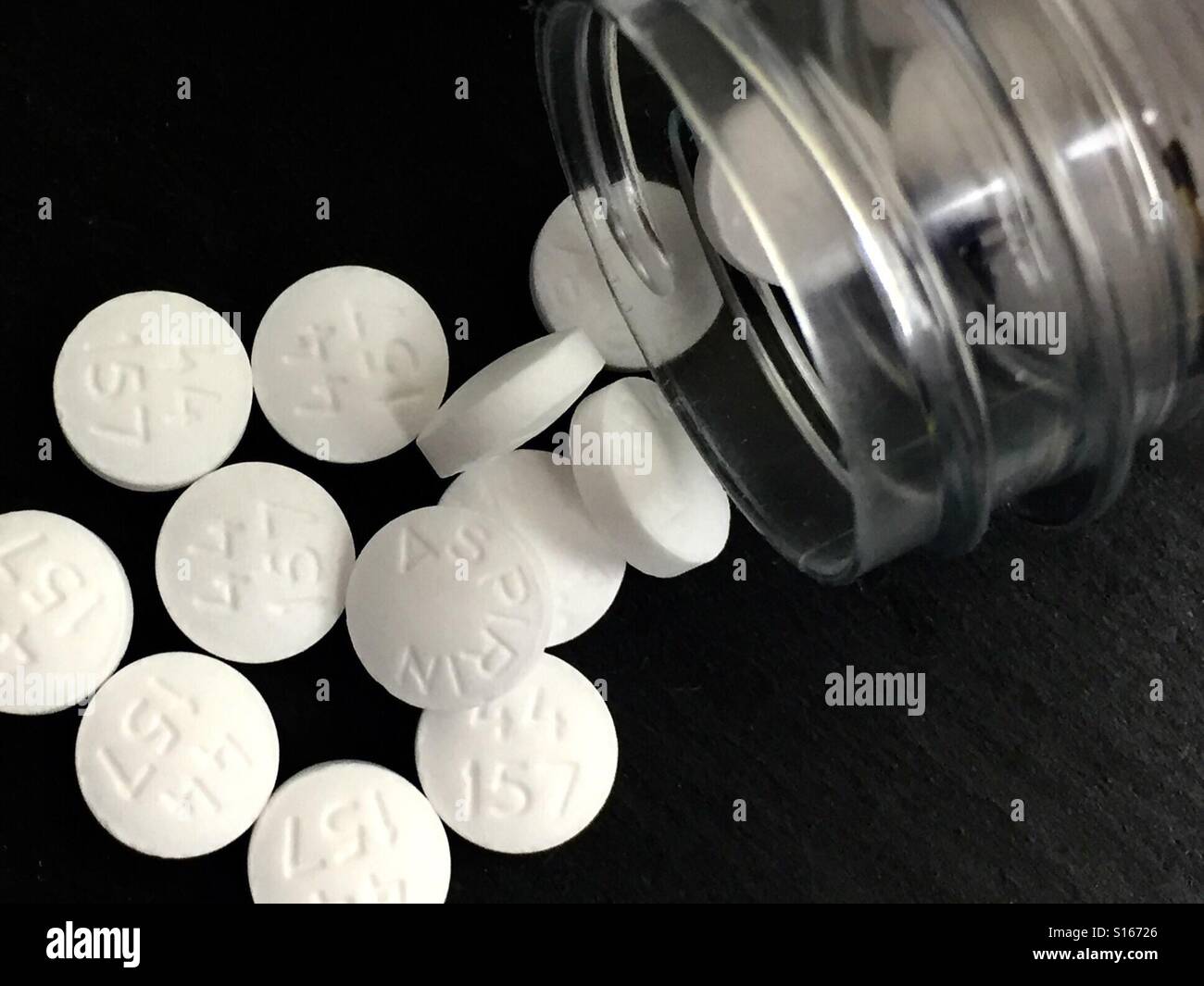 Aspirin pills on a black surface - Smartphone Captured Stock Image