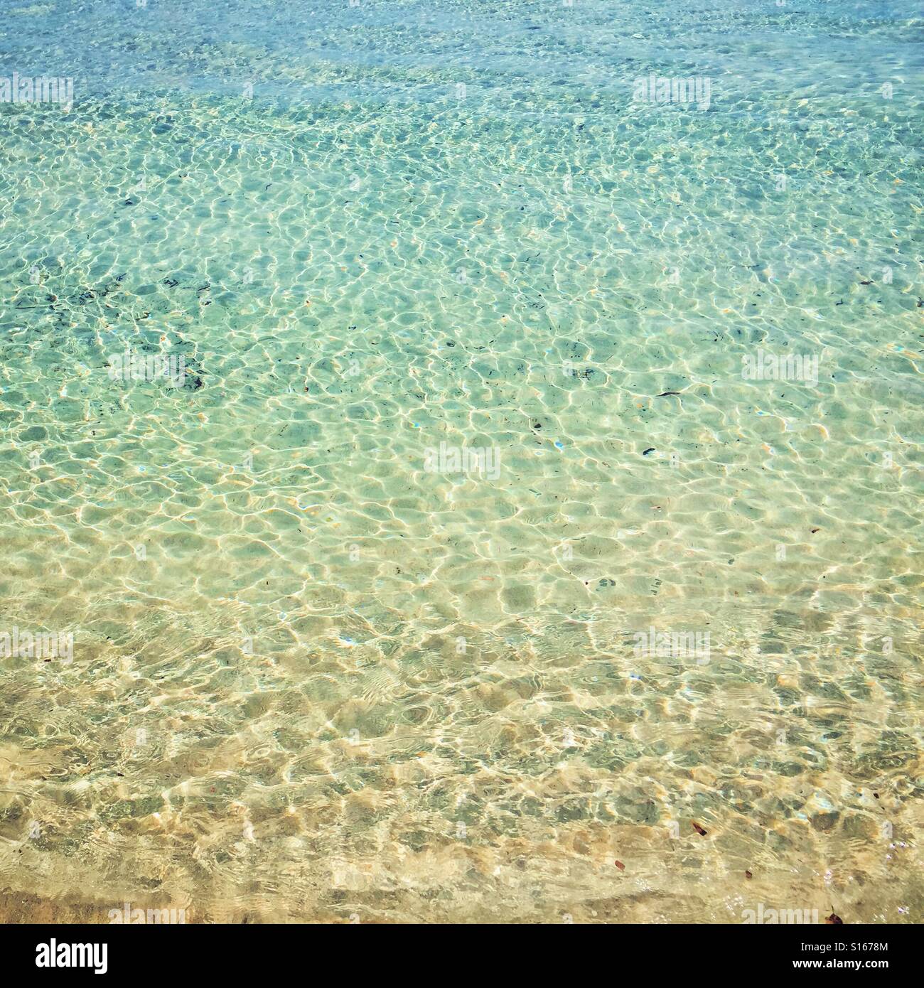 Ripples on the clear blue sea glistening in the summer sun Stock Photo