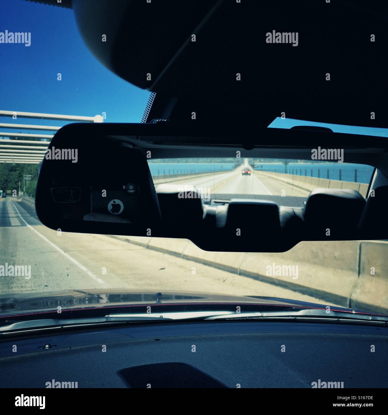 Road ahead of me, road in rear mirror behind - Smartphone Captured Stock Image