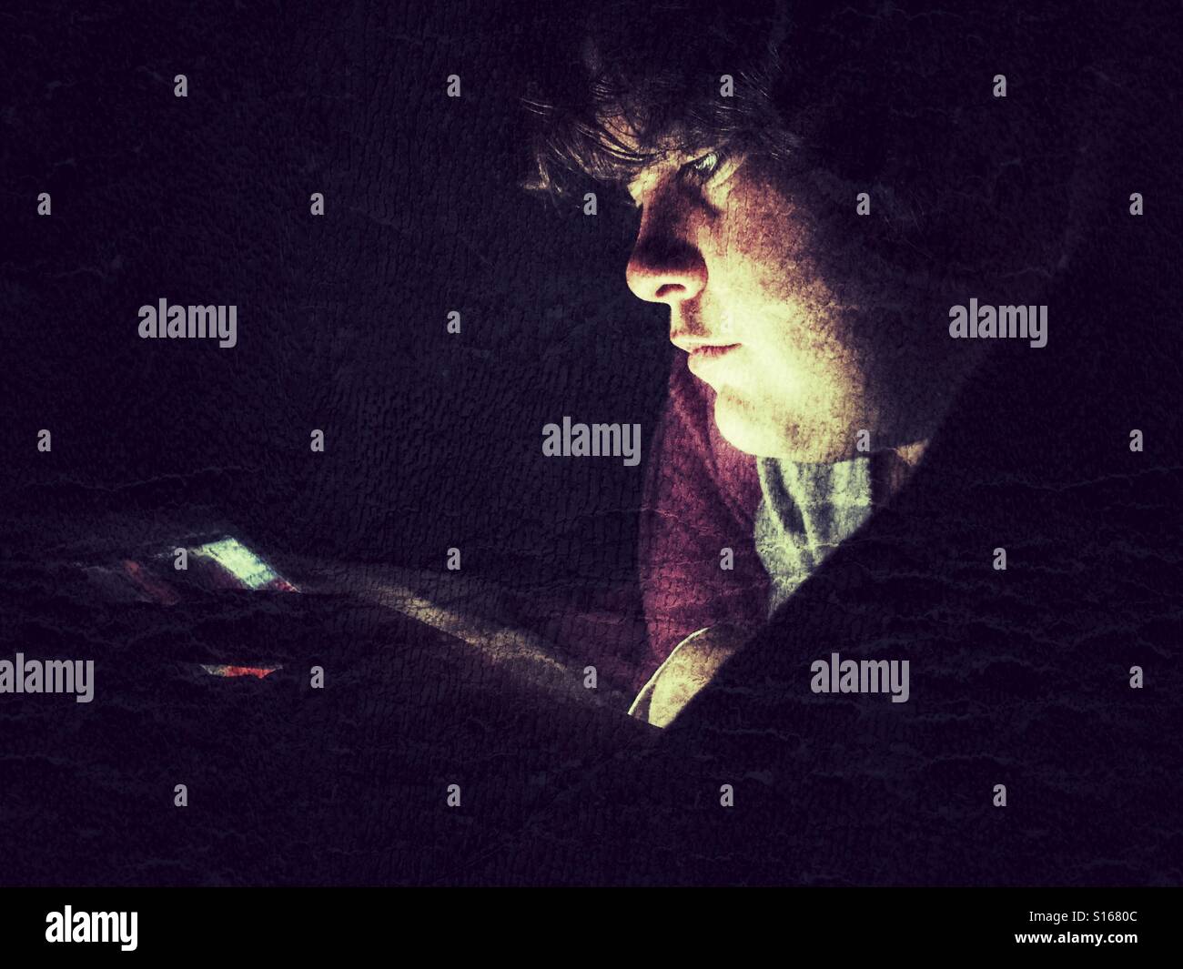 Teenager using iPad at night - Smartphone Captured Stock Image