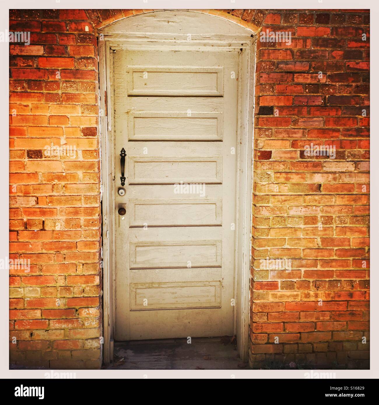 Old wooden door in a brick wall Stock Photo Alamy