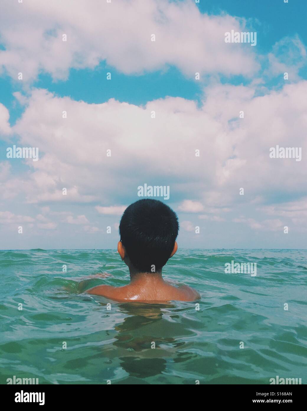 Boy swimming in the sea Stock Photo