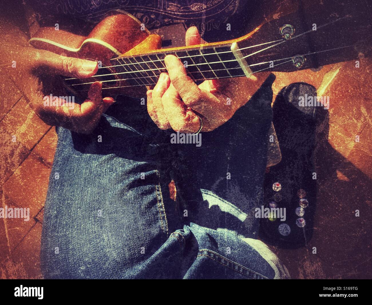Playing an O'Nino ukulele, close up - Smartphone Captured Stock Image