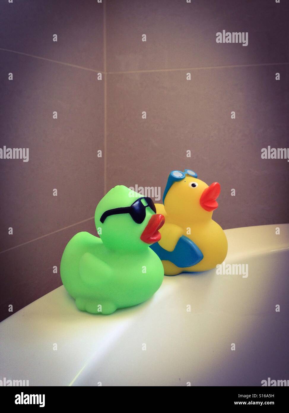 Baby bathing bath tub ducks Stock Photo