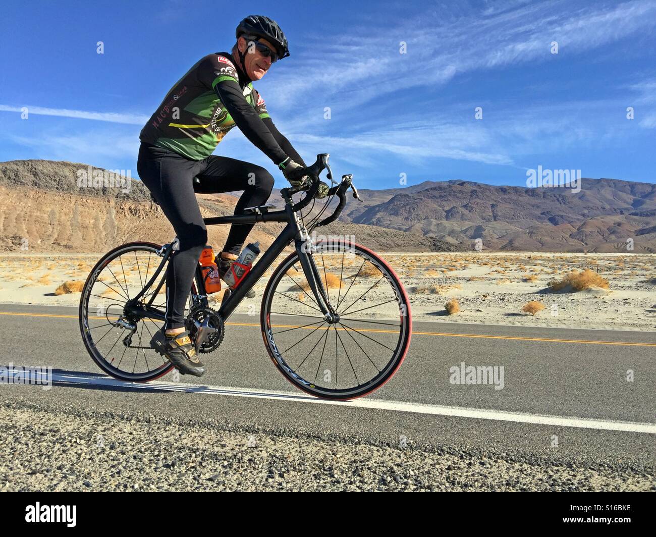 Senior riding Death Valley Stock Photo