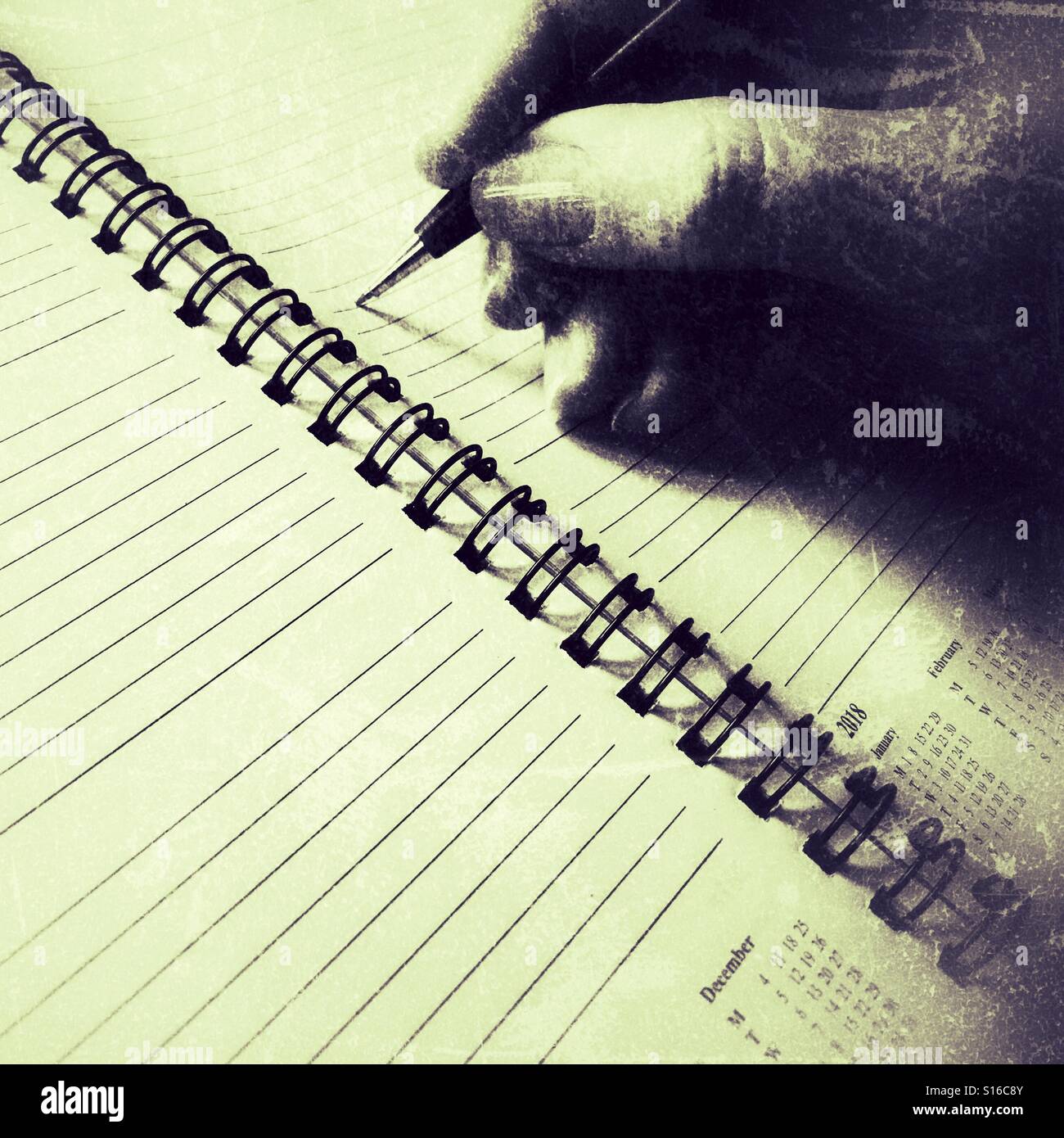 Person writing in a diary - Smartphone Captured Stock Image