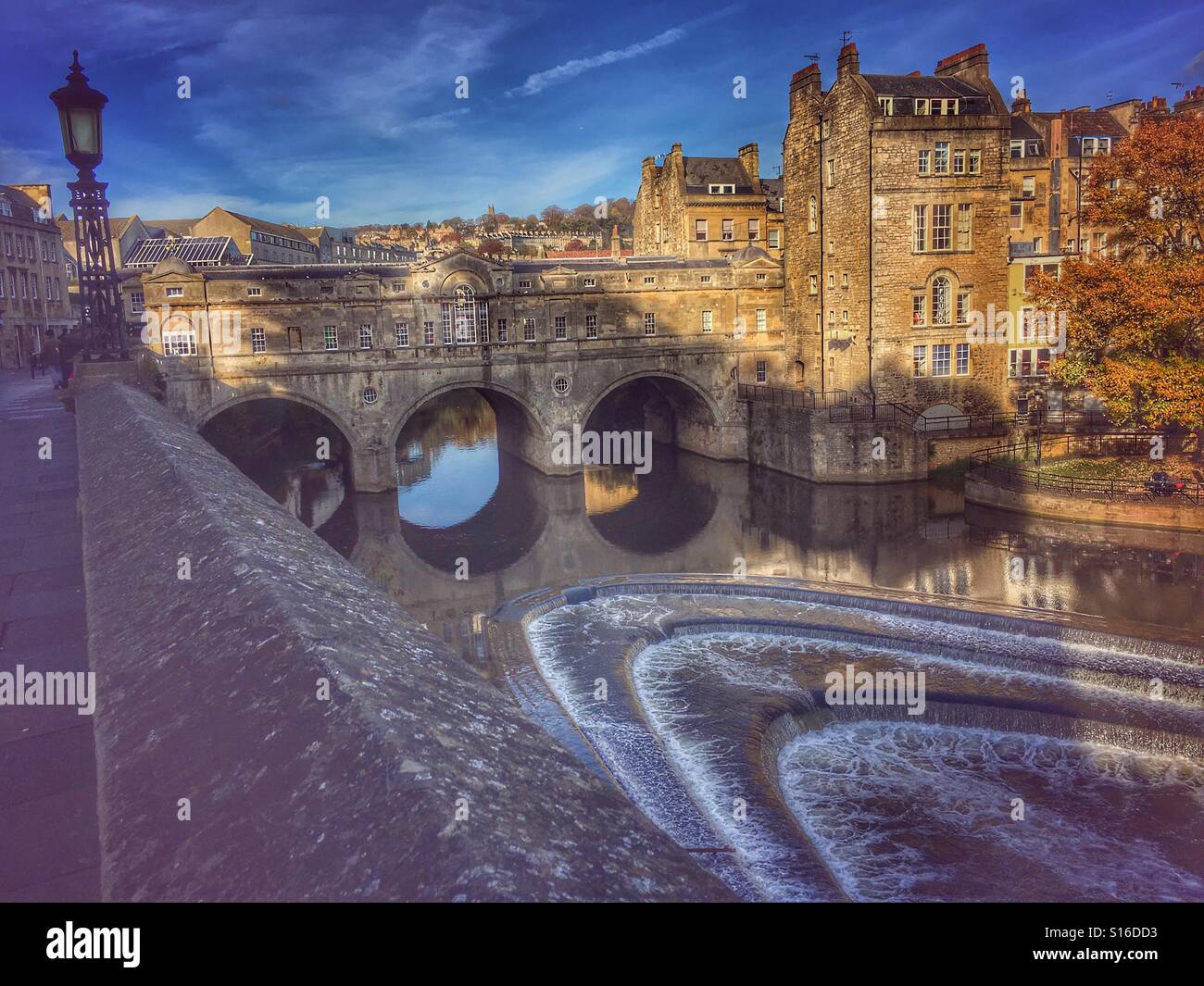 Pulteney Bridge, a Palladian bridge lined with shops, crosses the River Avon in Bath, England. - Smartphone Captured Stock Image