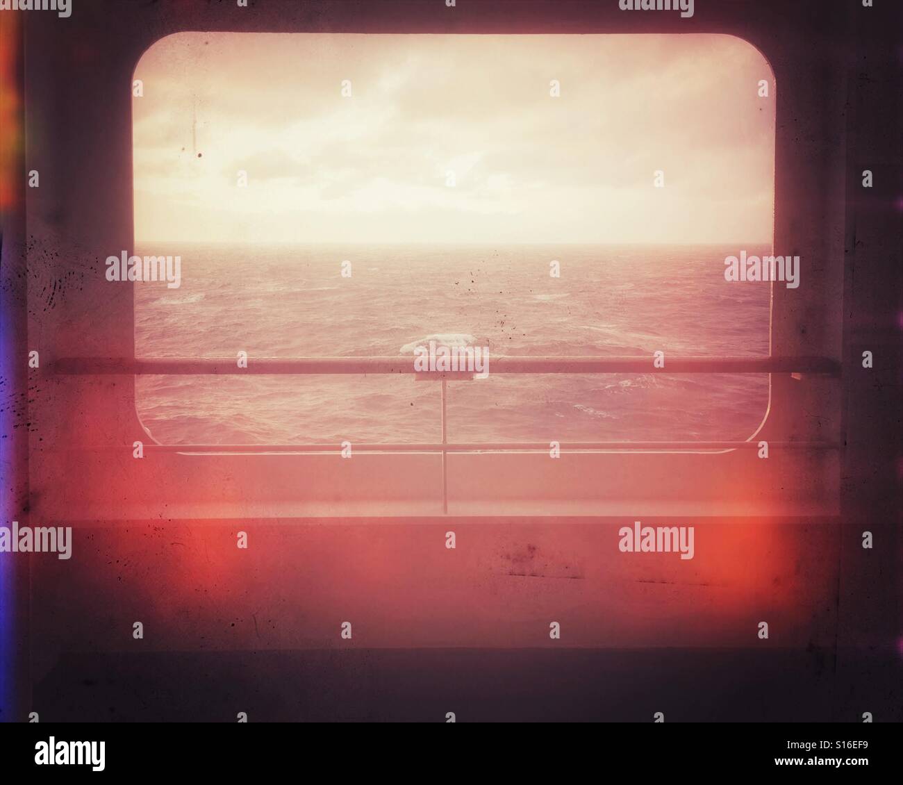 Dusk over the ocean. The Atlantic framed by an opening on an ocean liner, vintage style - Smartphone Captured Stock Image