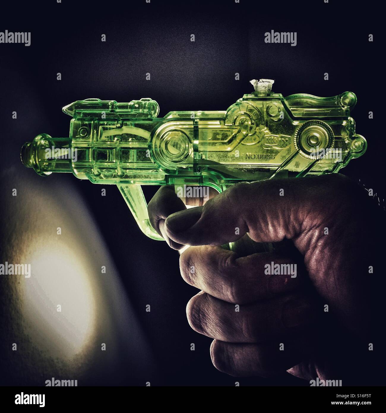 Green plastic water pistol Stock Photo