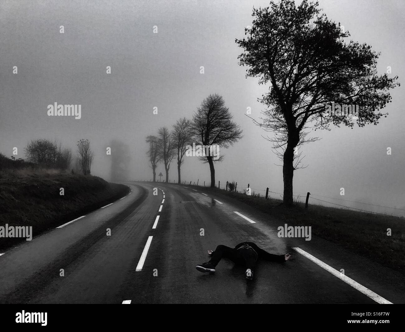 Man lying on the road - Smartphone Captured Stock Image
