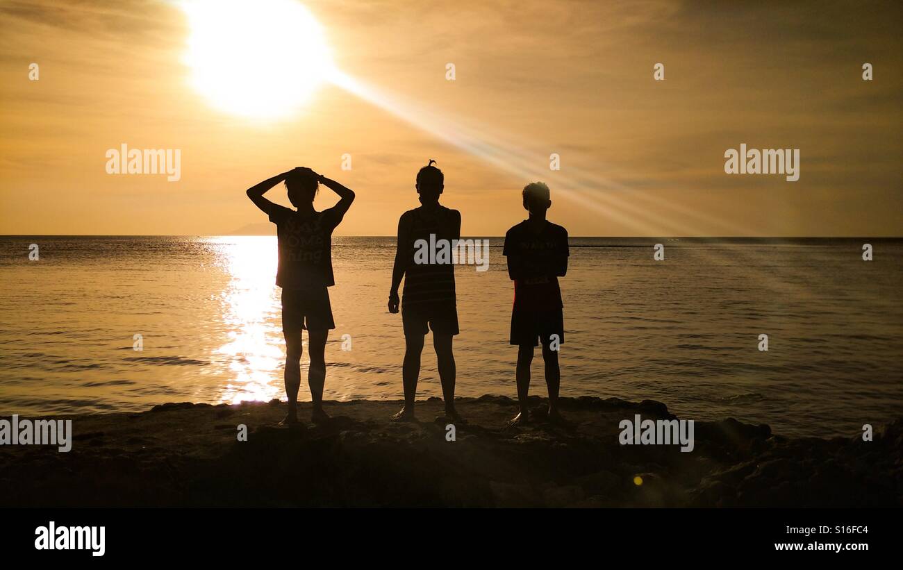 Photos of 3 Friends in shadows Stock Photo