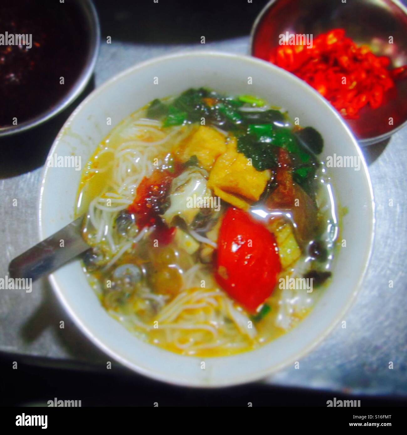 Bowl of spicy Vietnamese Noodle soup at a street market in Hanoi