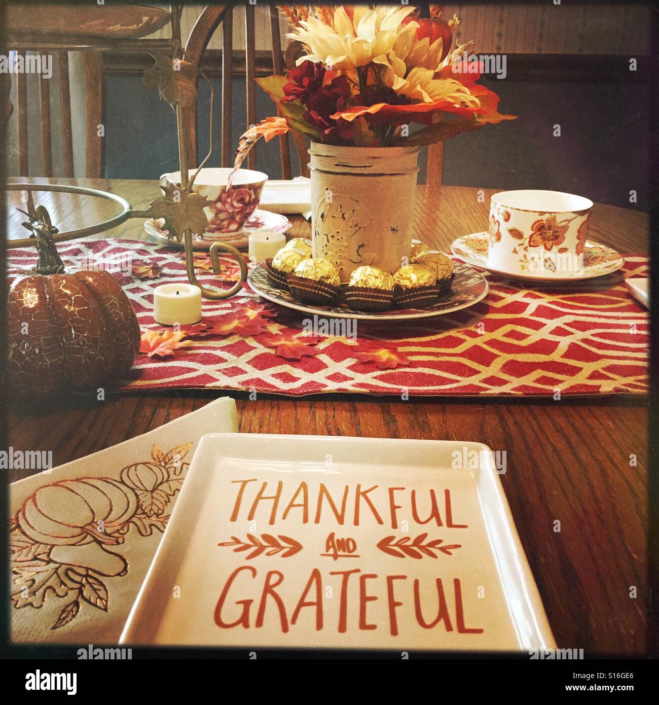 A table prepared for a fall luncheon. A plate has the words 'thankful and grateful' written on it. - Smartphone Captured Stock Image