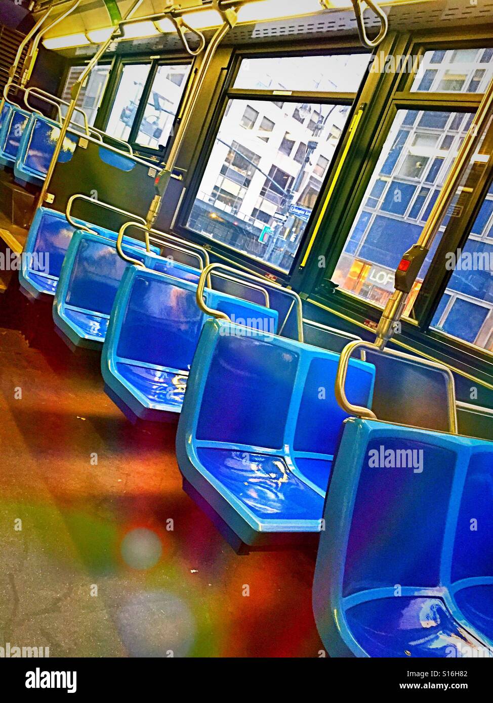 Bus seats in an empty New York City bus interior, USA - Smartphone Captured Stock Image
