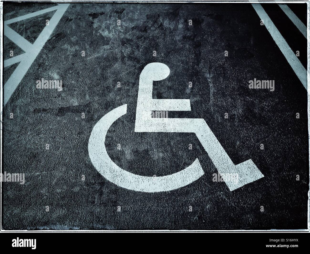 A grunge effect image of a disabled person's reserved car parking space. These specially allocated areas are designed to give people closer access to buildings and facilities. Photo © COLIN HOSKINS. - Smartphone Captured Stock Image