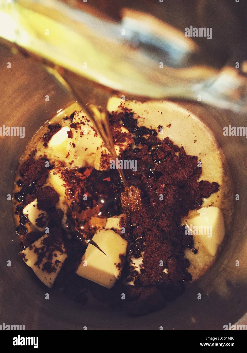 Pouring golden syrup into pan to make flapjacks - Smartphone Captured Stock Image