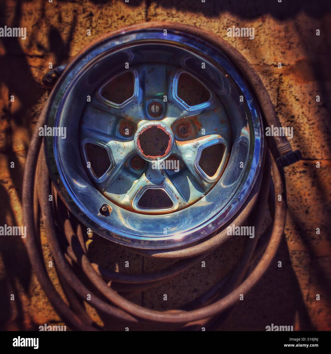 Hubcap and hose Stock Photo