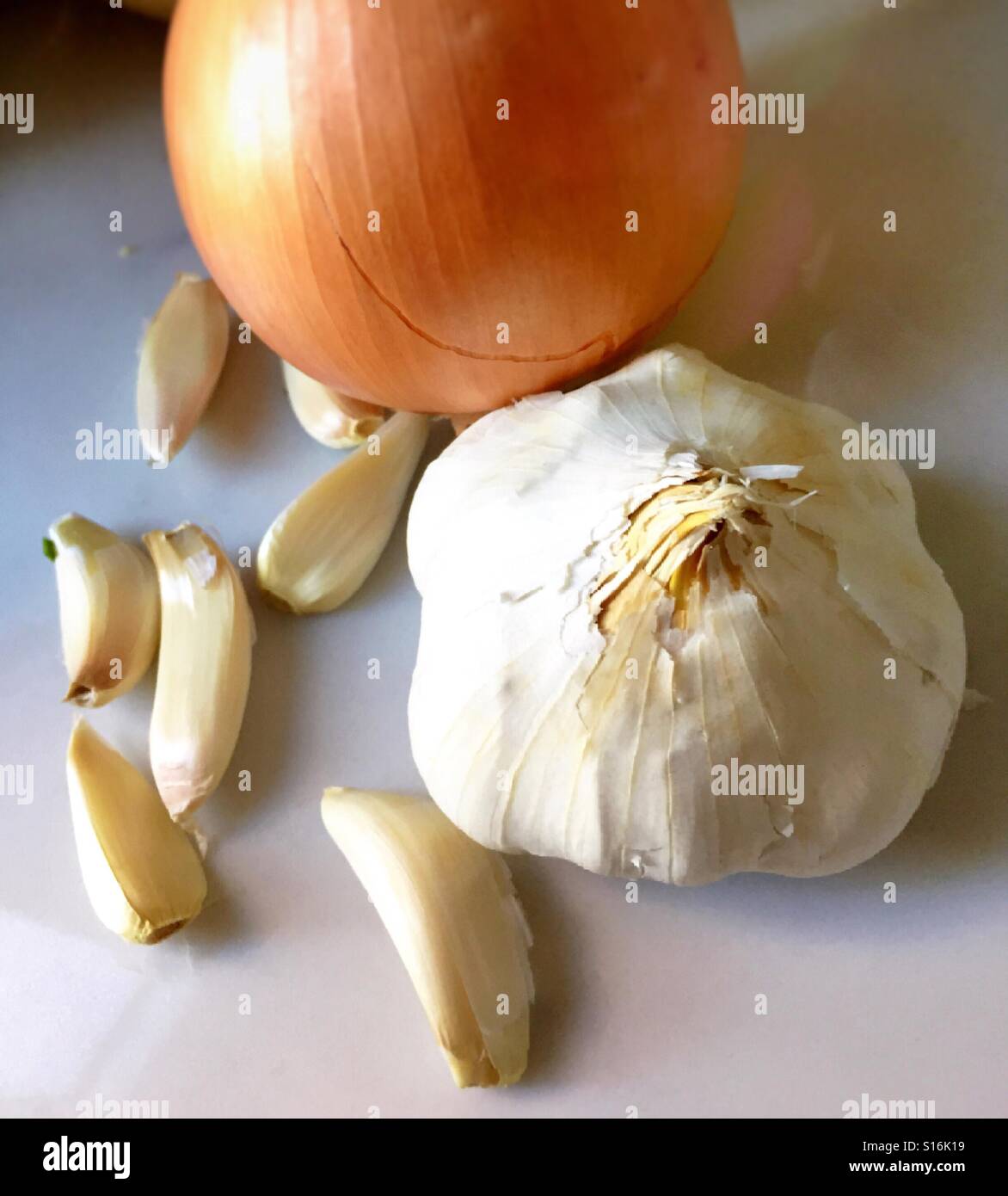 Still life of an onion , bulb and cloves of garlic on kitchen counter - Smartphone Captured Stock Image