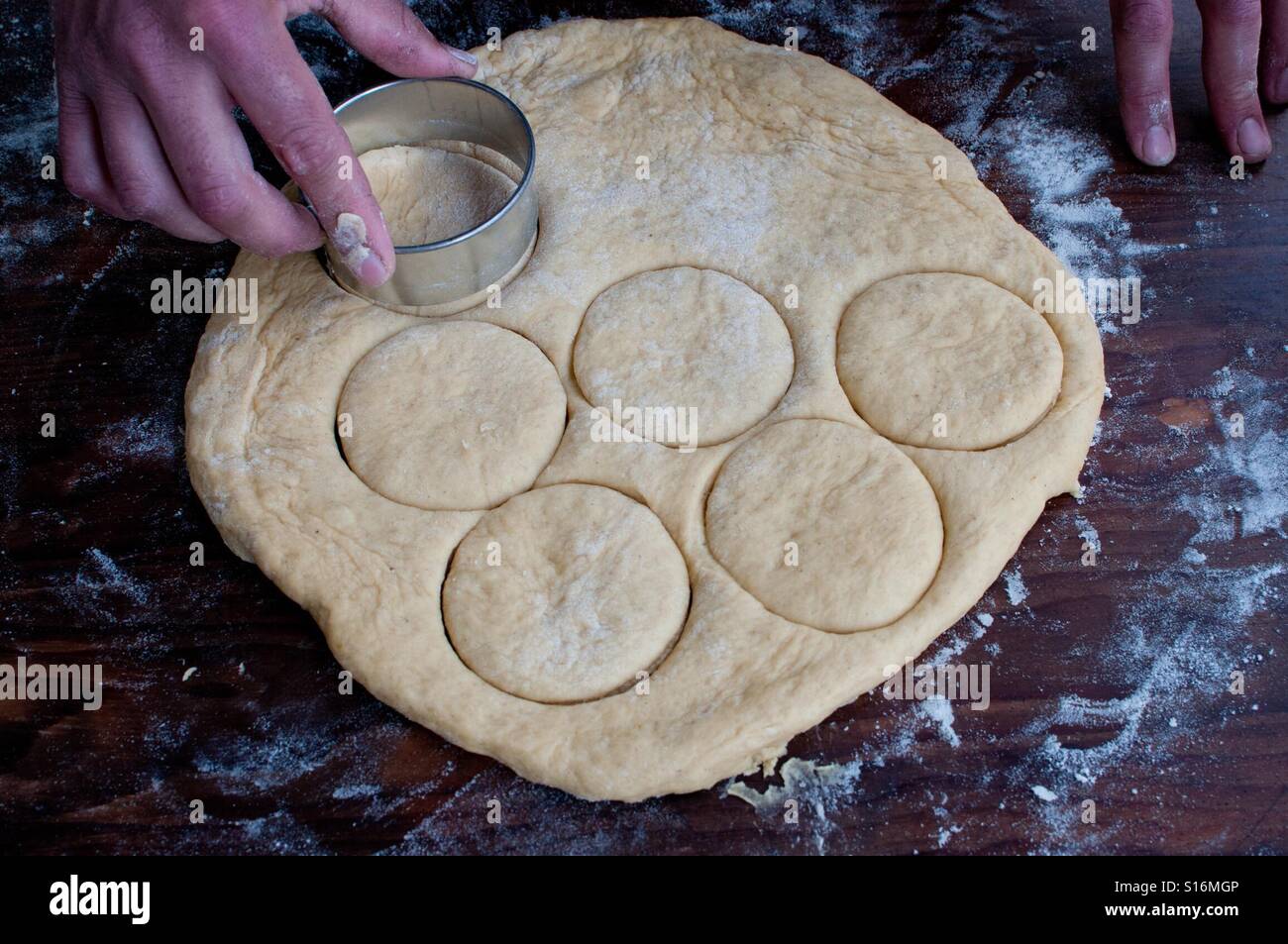 Cutting circles in pastry for doughnuts Stock Photo