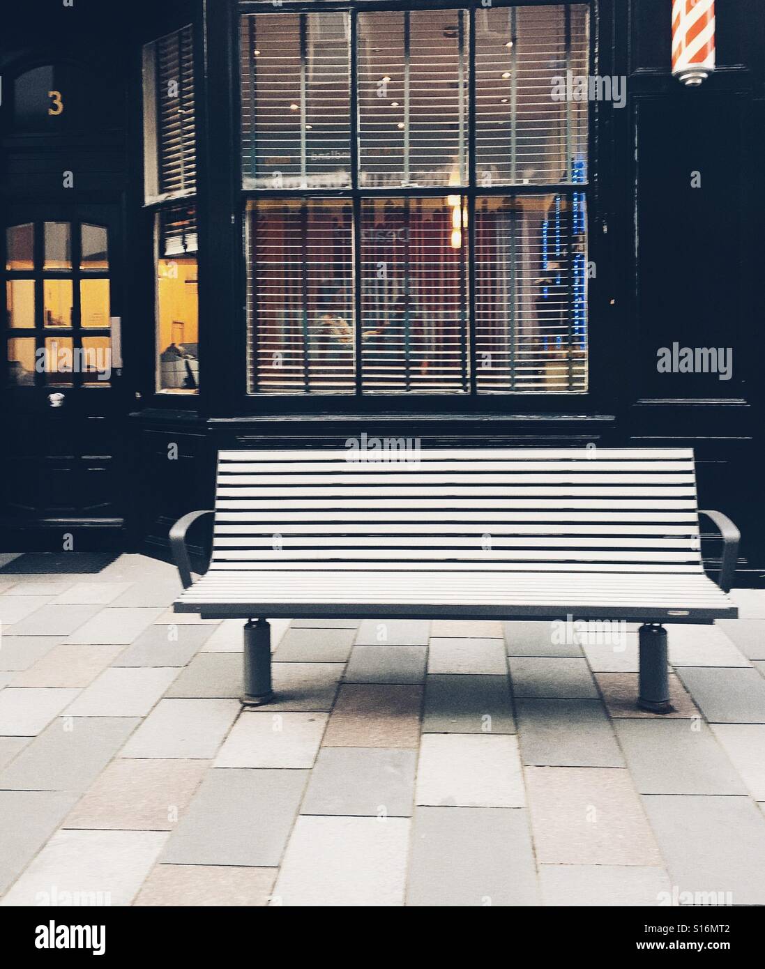 Victorian shop facade with empty bench Stock Photo
