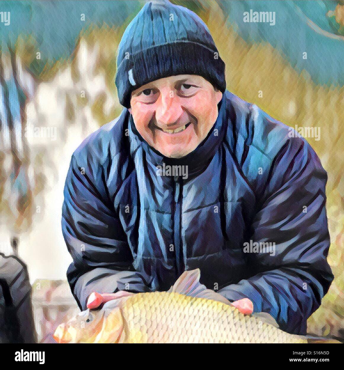 Fisherman with a common carp in winter - Smartphone Captured Stock Image