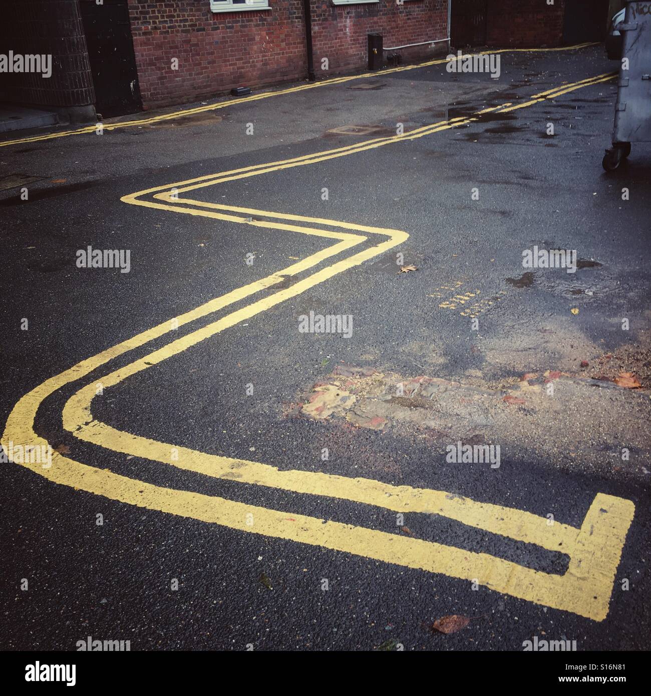 Crazy Double Yellow Lines outlining the letter W or E - Smartphone Captured Stock Image