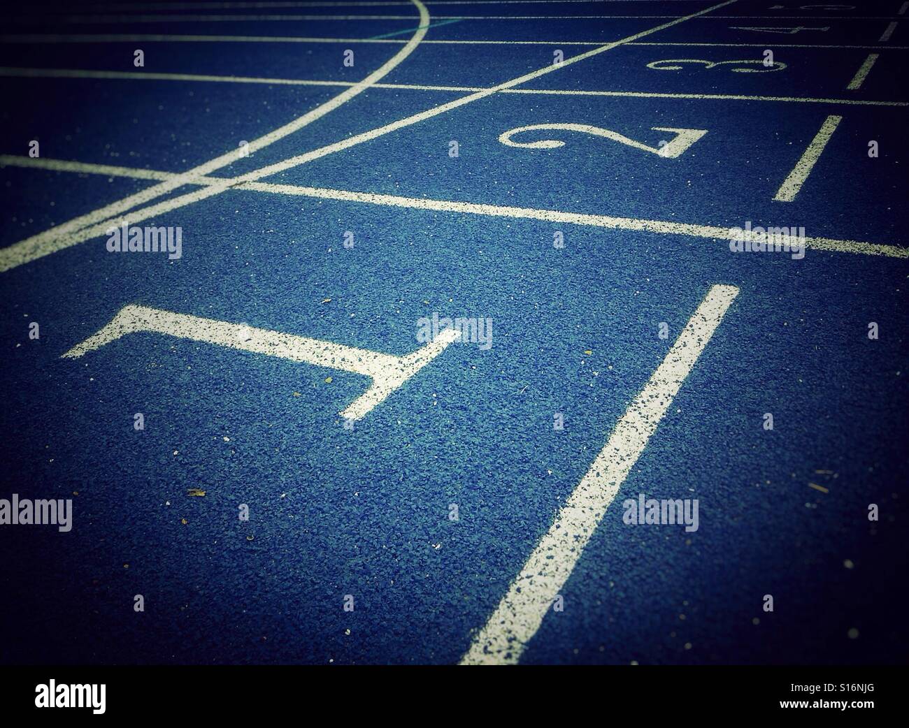 Ordinal numbers on a blue athletic field track - Smartphone Captured Stock Image