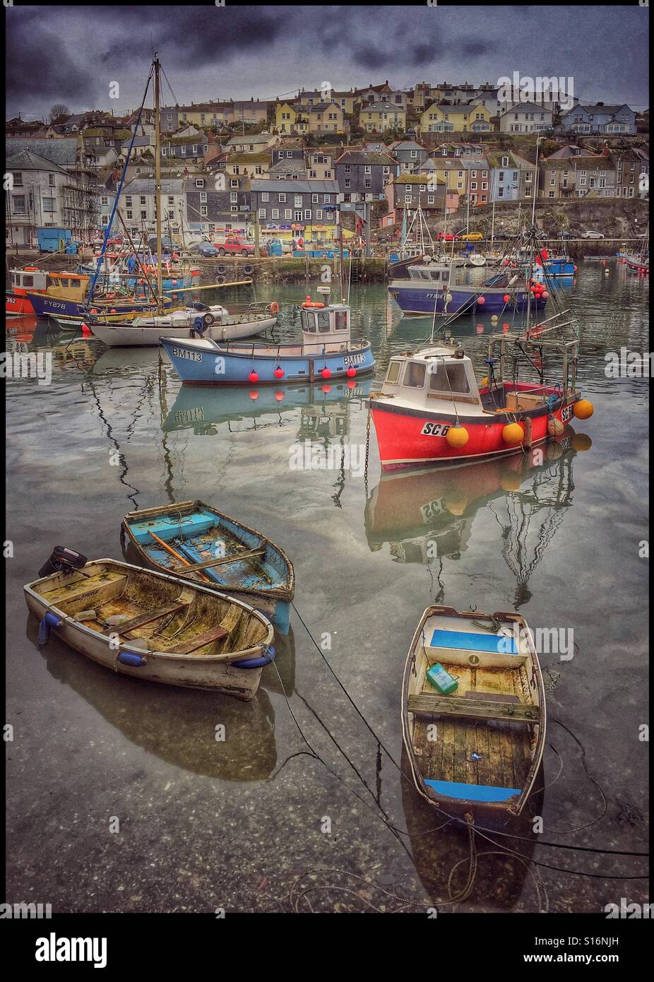A winter view of Mevagissey Harbour, Cornwall, England. Boats await another fishing trip. The tide is slowly coming in. Photo Credit - © COLIN HOSKINS. - Smartphone Captured Stock Image