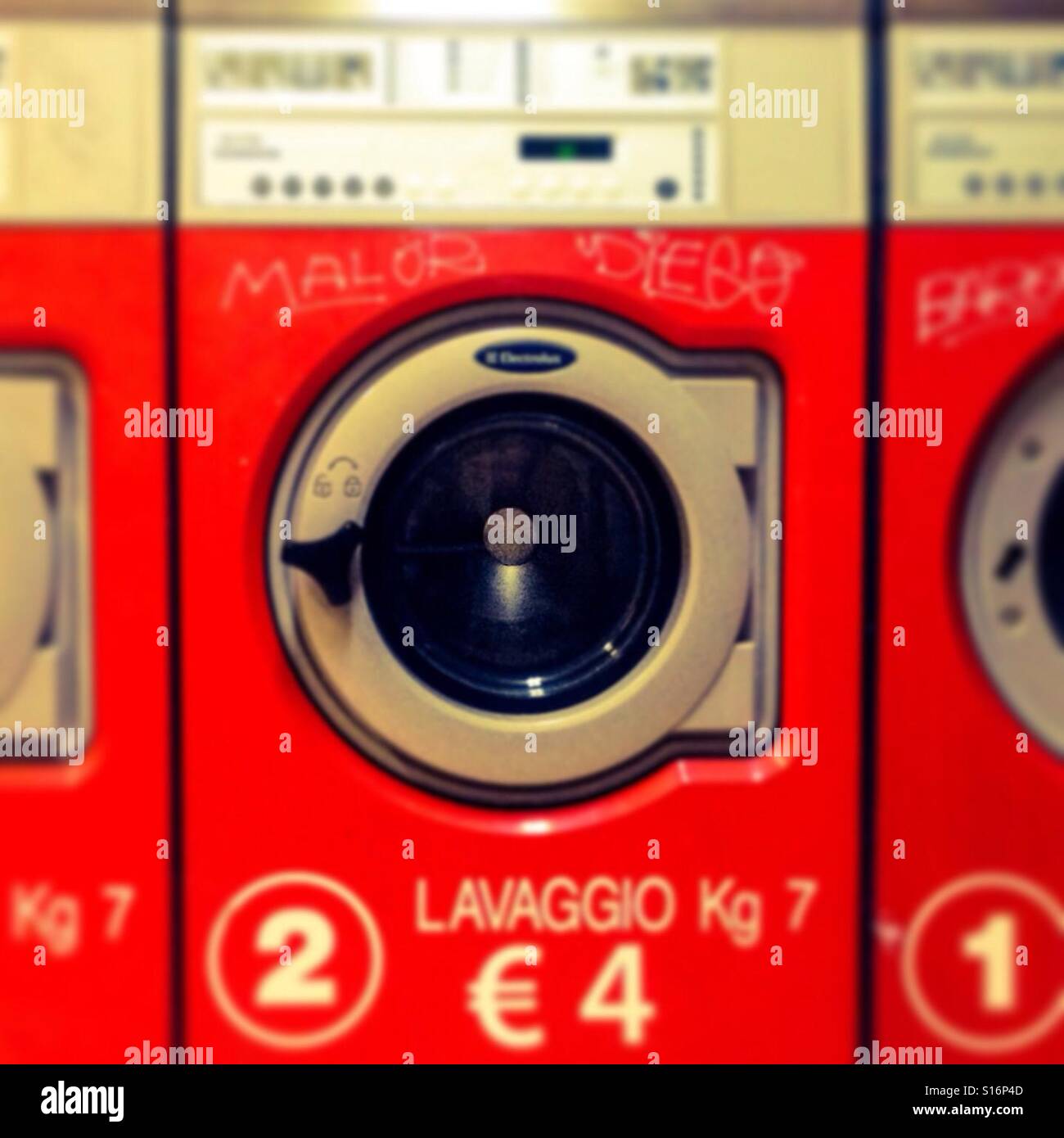 red industrial washing machine, laundrette Stock Photo