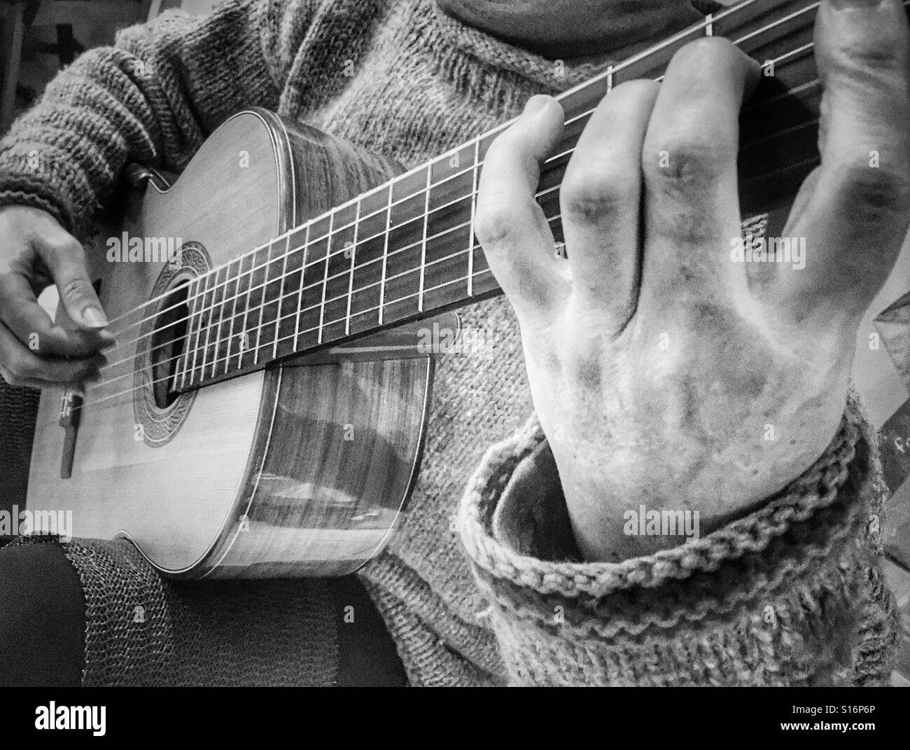 Woman playing a Greg Smallman Smallman guitar. Close up of hands. - Smartphone Captured Stock Image